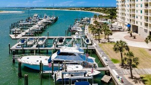 A marina with multiple boats docked, a hotel with balconies, and a clear view of the beach. - Incredible Views - Magnificent Sunsets
I Little Piece of Heaven
 (Beaufort)