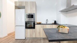 A modern kitchen with a built-in oven, microwave, and a refrigerator. - A (VA013.2 ) TH Ayuntamiento 2D (Valencia / València)