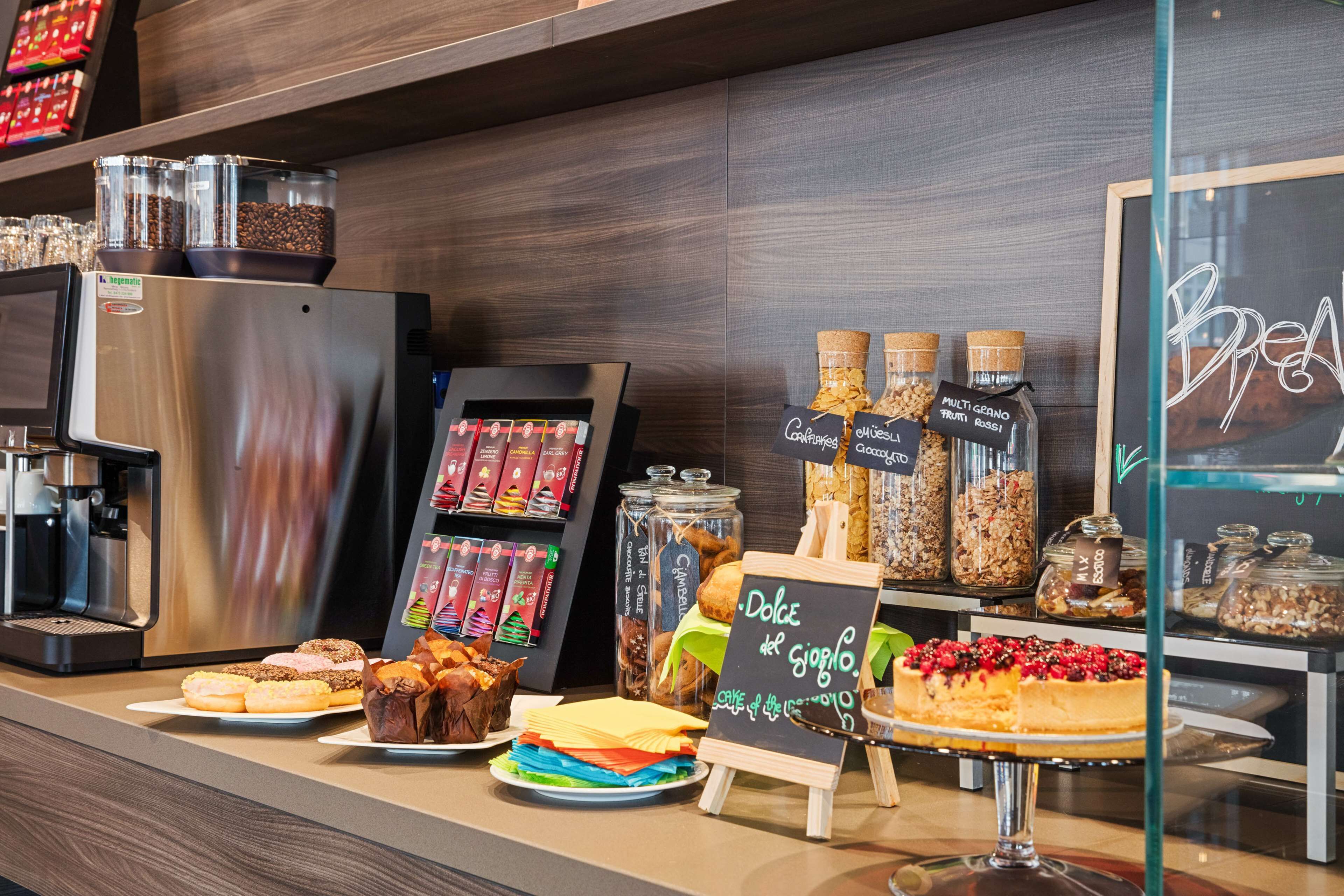 A bakery display with various pastries and a coffee machine.