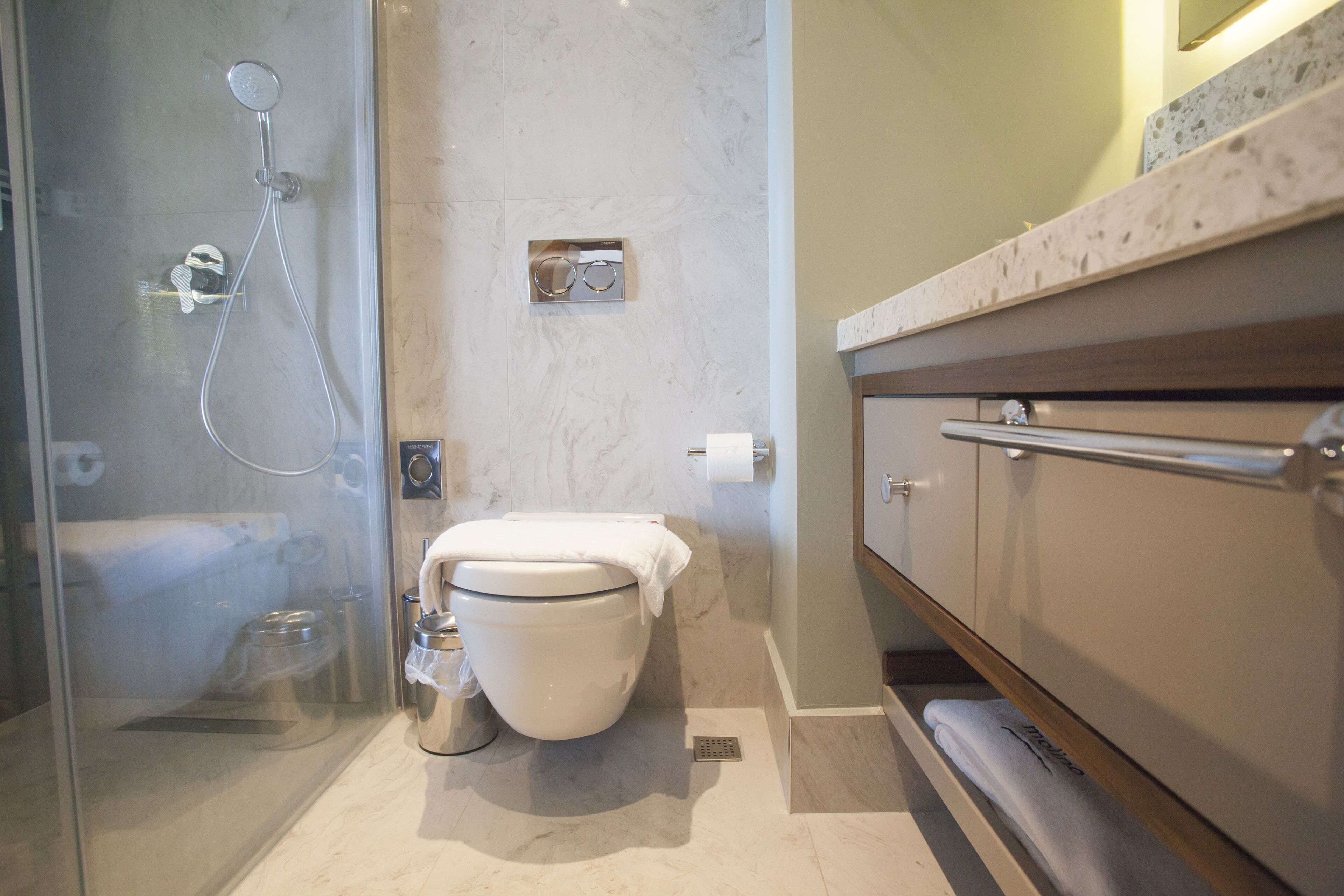 Bathroom | Designer toiletries, hair dryer, slippers, bidet