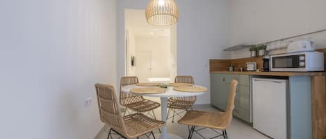 A modern kitchen with a dining area.