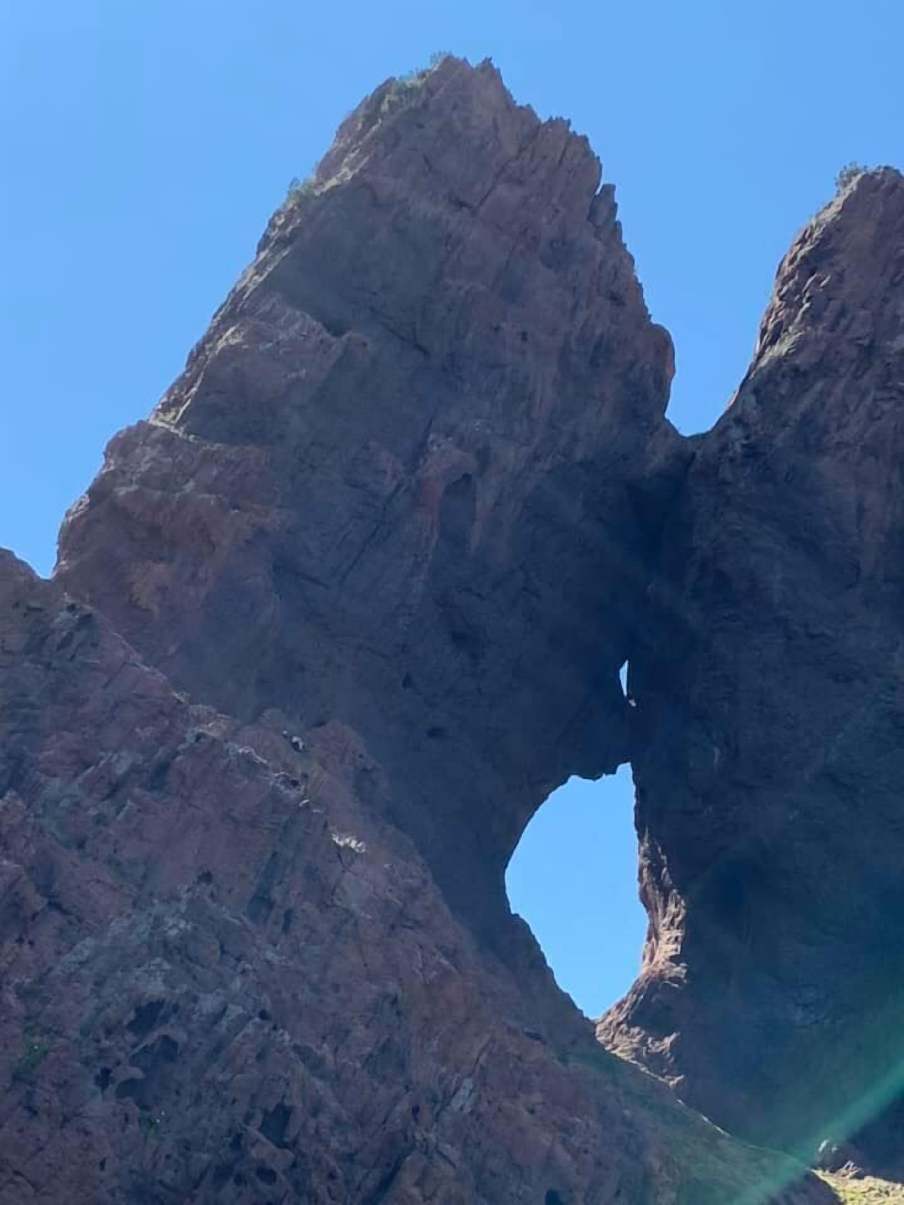 A natural rock formation with a large arch.