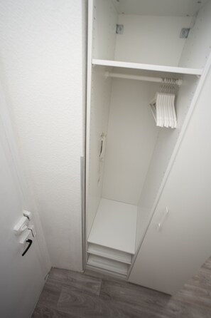 Bathroom features a shower enclosure, towel rack, and a towel.