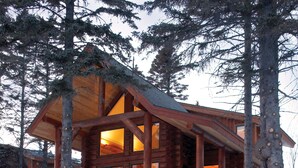 A log cabin with a balcony and a staircase leading to the upper level. - Temperance Landing on Lake Superior (Schroeder)