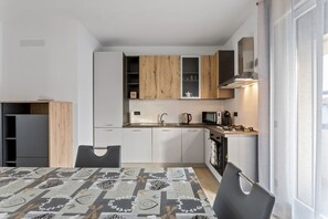 Apartment, 3 Bedrooms | Private kitchen | Full-sized fridge, stovetop, electric kettle, cookware/dishes/utensils