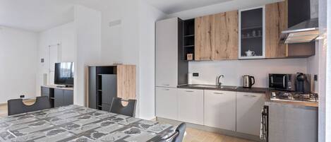 Apartment, 3 Bedrooms | Private kitchen | Full-size fridge, stovetop, electric kettle, cookware/dishes/utensils