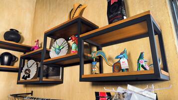 A wall with shelves displaying various decorative items and a coffee machine.