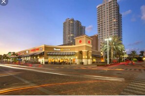 A Panera Bread restaurant with a modern facade, located in a commercial area with high-rise buildings in the background. - Gorgeous Spot in Hallandale Beach With Pool!! (Hallandale Beach)