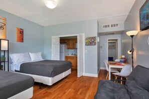 A compact hotel room with a bed, a desk, and a kitchenette. - Gorgeous Spot in Hallandale Beach With Pool!! (Hallandale Beach)