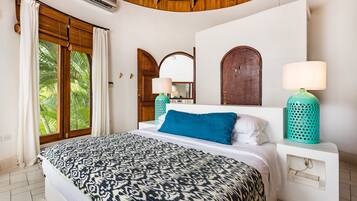 A bedroom with a bed, two wall-mounted lamps, a window with curtains, and a wooden ceiling.