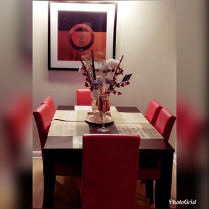 Enjoy meals with family and friends at this dining area, featuring a table for four and comfortable seating.