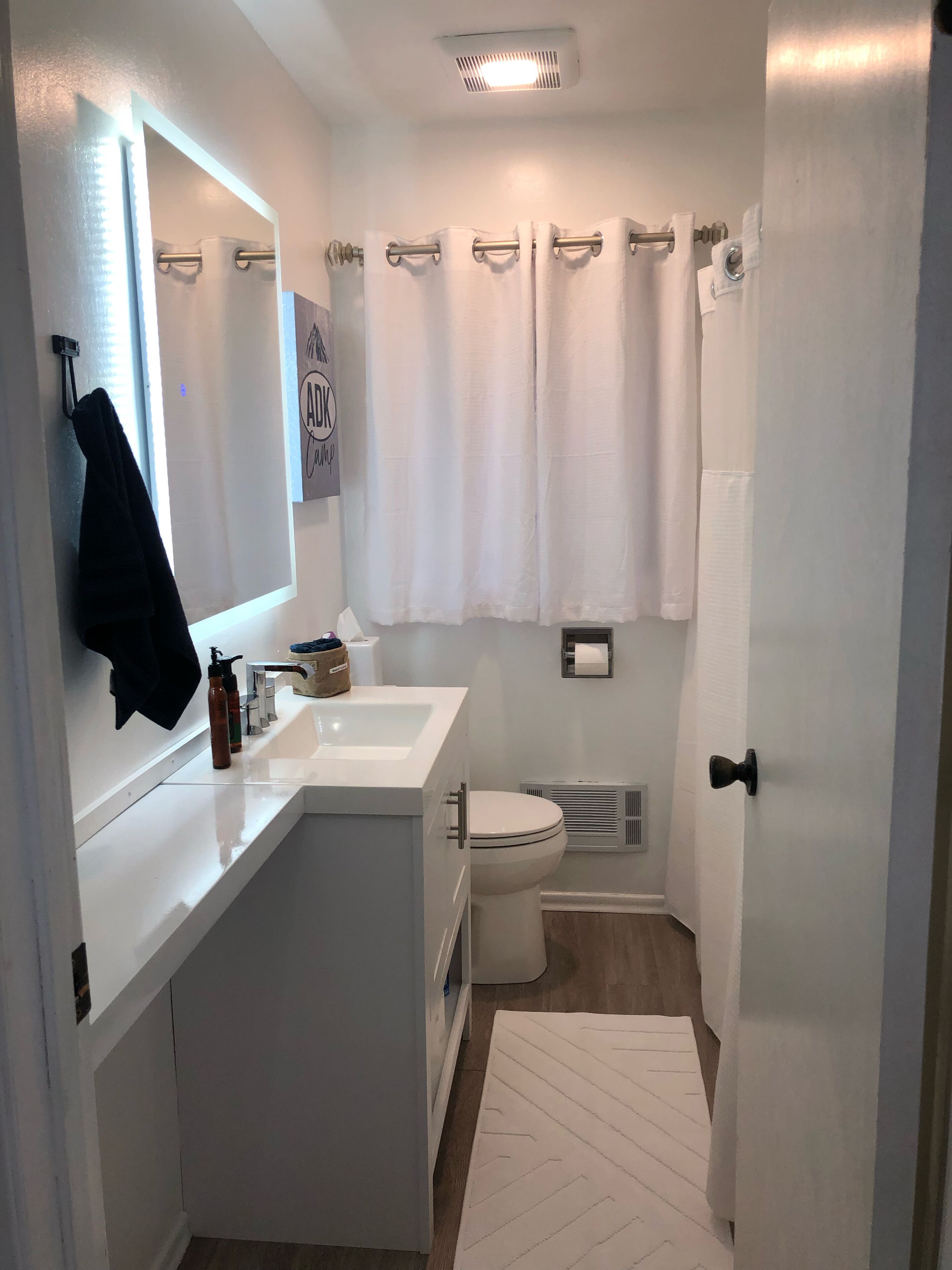 Main floor full bathroom.  Touch light mirror.  Shower and tub combination.