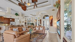 A spacious living area with leather sofas, a coffee table, and a large rug. - Backyard Oasis, Luxurious, Magnificent-Villa Triton's Tide- Cape Coral- Roelens Vacations (Cape Coral)