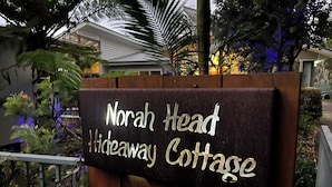A sign for Norah Head Hideaway Cottage.