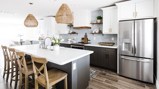 A modern kitchen with a central island, dark cabinetry, stainless steel appliances, and woven pendant lights. - Charming Home  - Sleeps 14 + Heated Pool + BBQ + 5-7 minutes to Old Town (Scottsdale)