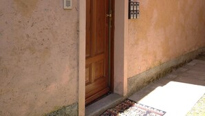 Une porte en bois dotée d’une fente pour le courrier et d’un interphone fixé au mur.