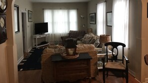 A living room with a sofa, armchairs, a TV, and a fireplace. - Historic and quiet St. Joseph neighborhood: Lovely comfortable 100 yo two story (St Joseph)