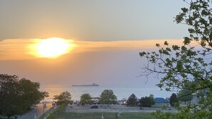 A sunset view over a body of water with a park, a roundabout, and a distant ship. - Historic and quiet St. Joseph neighborhood: Lovely comfortable 100 yo two story (St Joseph)