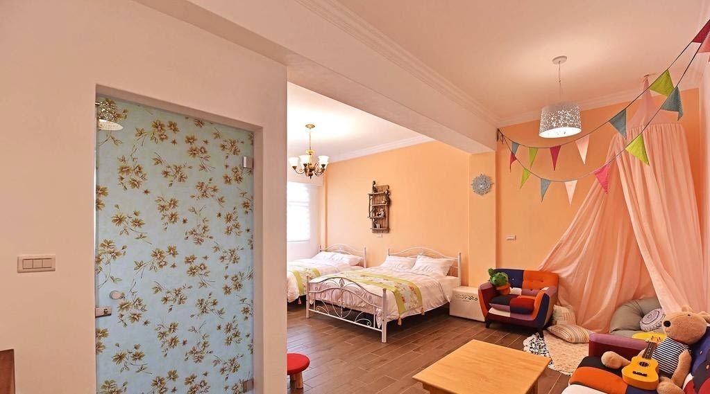 A bedroom with a bed, bedside table, and a chair.