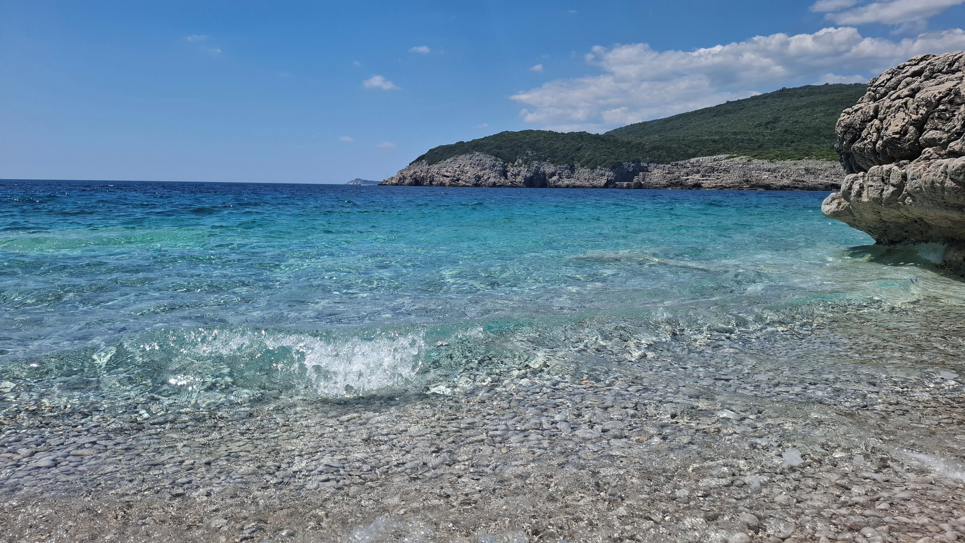 A clear coastal area with rocky terrain and a view of the sea.