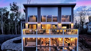 A modern two-story building with multiple balconies and large windows.