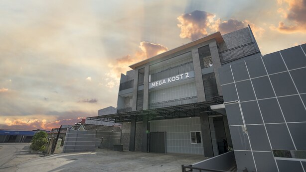 A building with a sign reading "MEGA KOST 2" and a covered entrance. - OYO 945 Mega Kost 2 (Palembang)