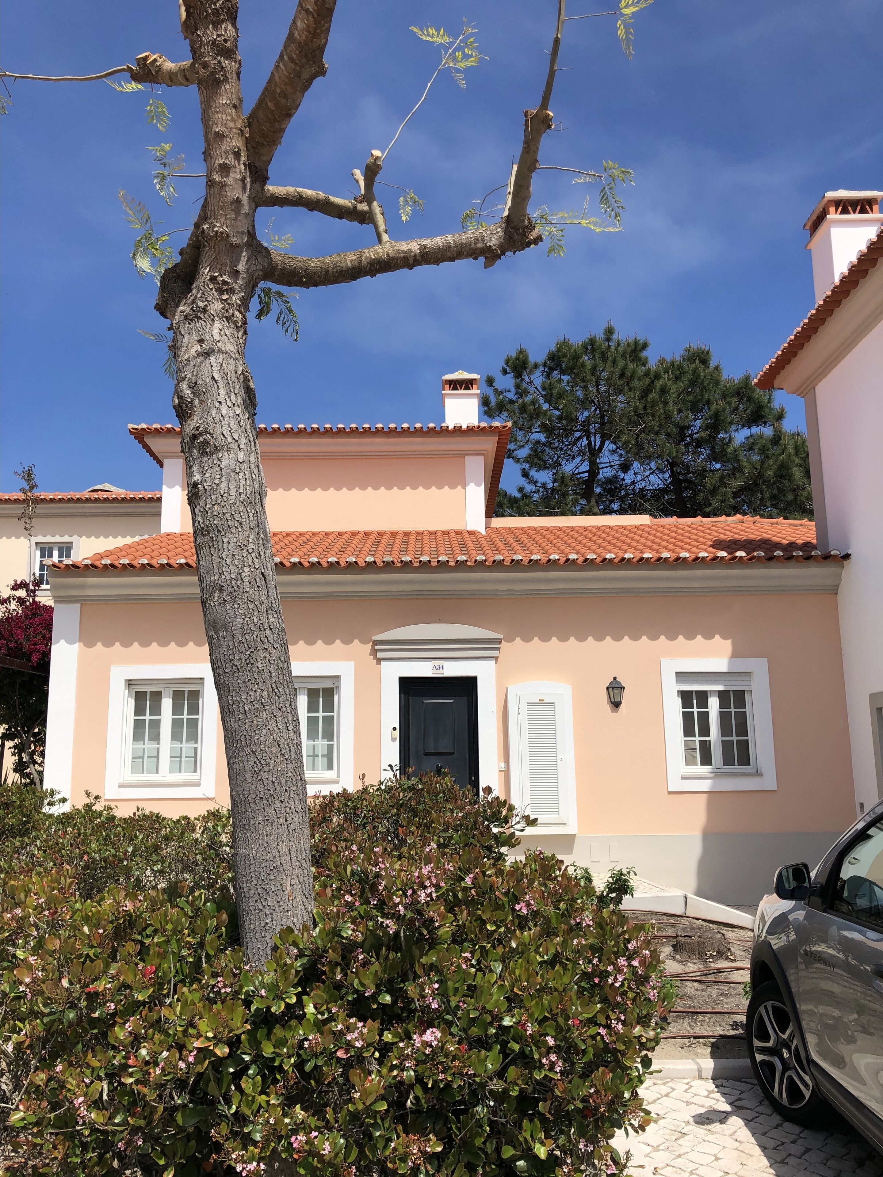 A building with a tiled roof, a door, and windows.