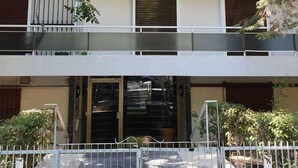 A multi-story residential building with balconies, a gated entrance, and surrounding greenery. - Bright 2BD Apartment in Psychiko (Neo Psichiko)