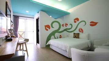 A modern hotel room with a bed, a desk, and a chair.