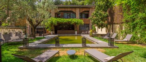 Seasonal outdoor pool, open 10:00 AM to 7:00 PM, pool umbrellas