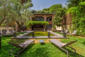 Een seizoensgebonden buitenzwembad en parasols bij het zwembad