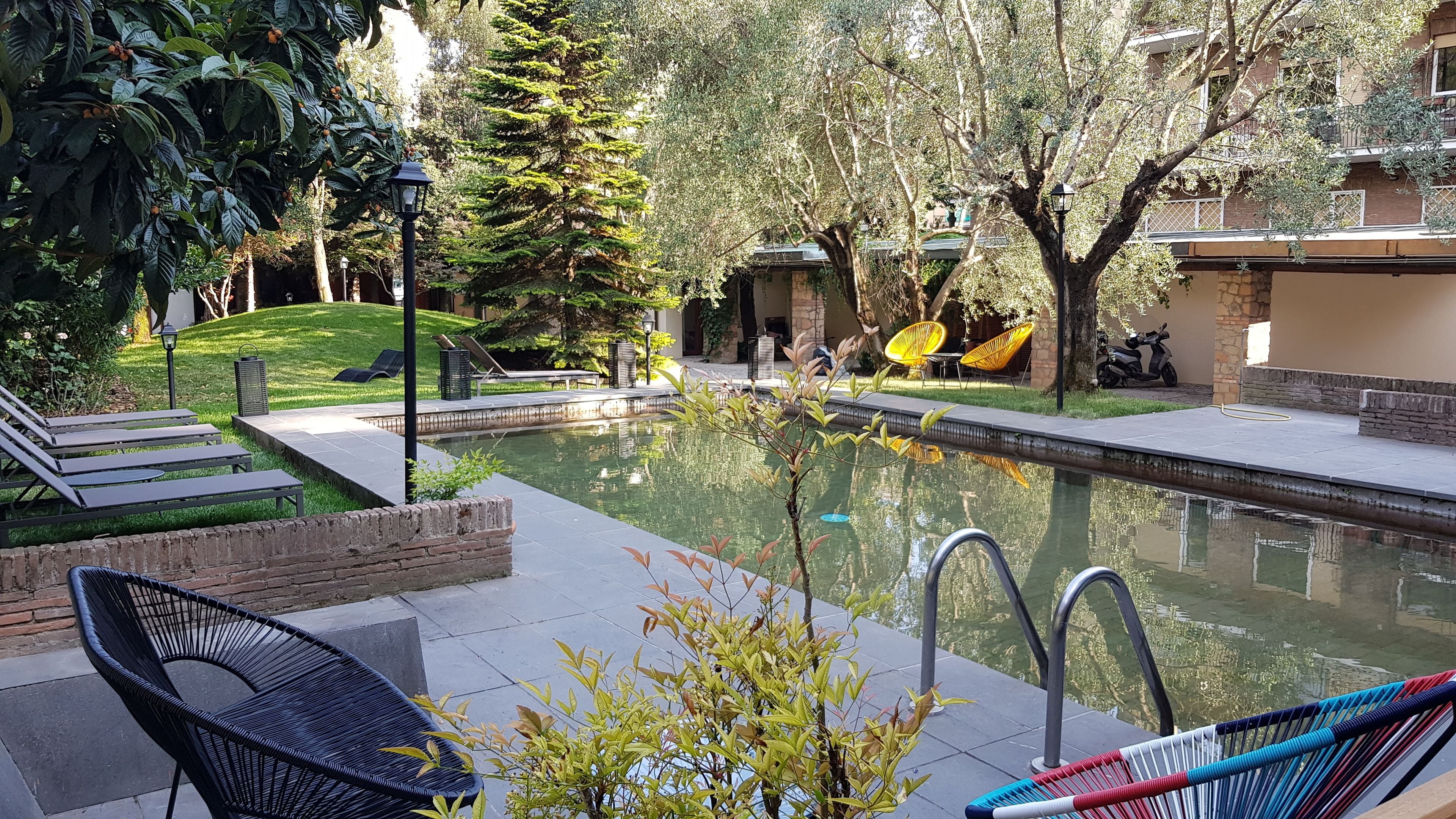 Seasonal outdoor pool, open 10:00 AM to 7:00 PM, pool umbrellas