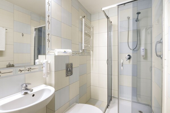 A modern bathroom with a glass-enclosed shower, a white sink, and a towel rack.