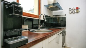 A kitchen with a built-in espresso machine, a stainless steel sink, and a window above the counter. - Villa 22 ,beautiful villa with a gorgeous view on Boka bay (Herceg Novi)