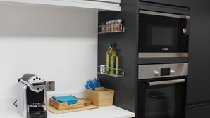 A modern kitchen with a coffee maker, a microwave, and a built-in oven. - Fabulous Apartment in the City of Ripon, close to Cathedral with private parking (Ripon)
