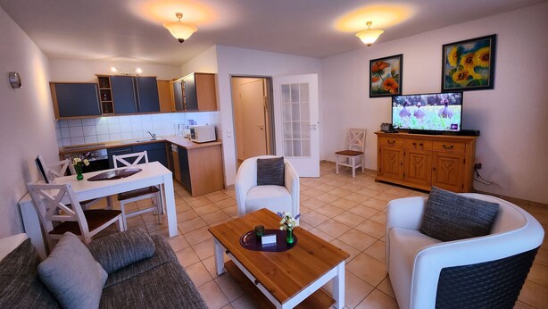 A compact living space with a kitchenette, dining area, and seating arrangement.