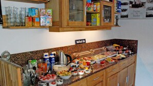A buffet setup with various food items and beverages. - Ferienappartement 02 - Pension/holiday apartments in the Ostseebad Sellin (Sellin)