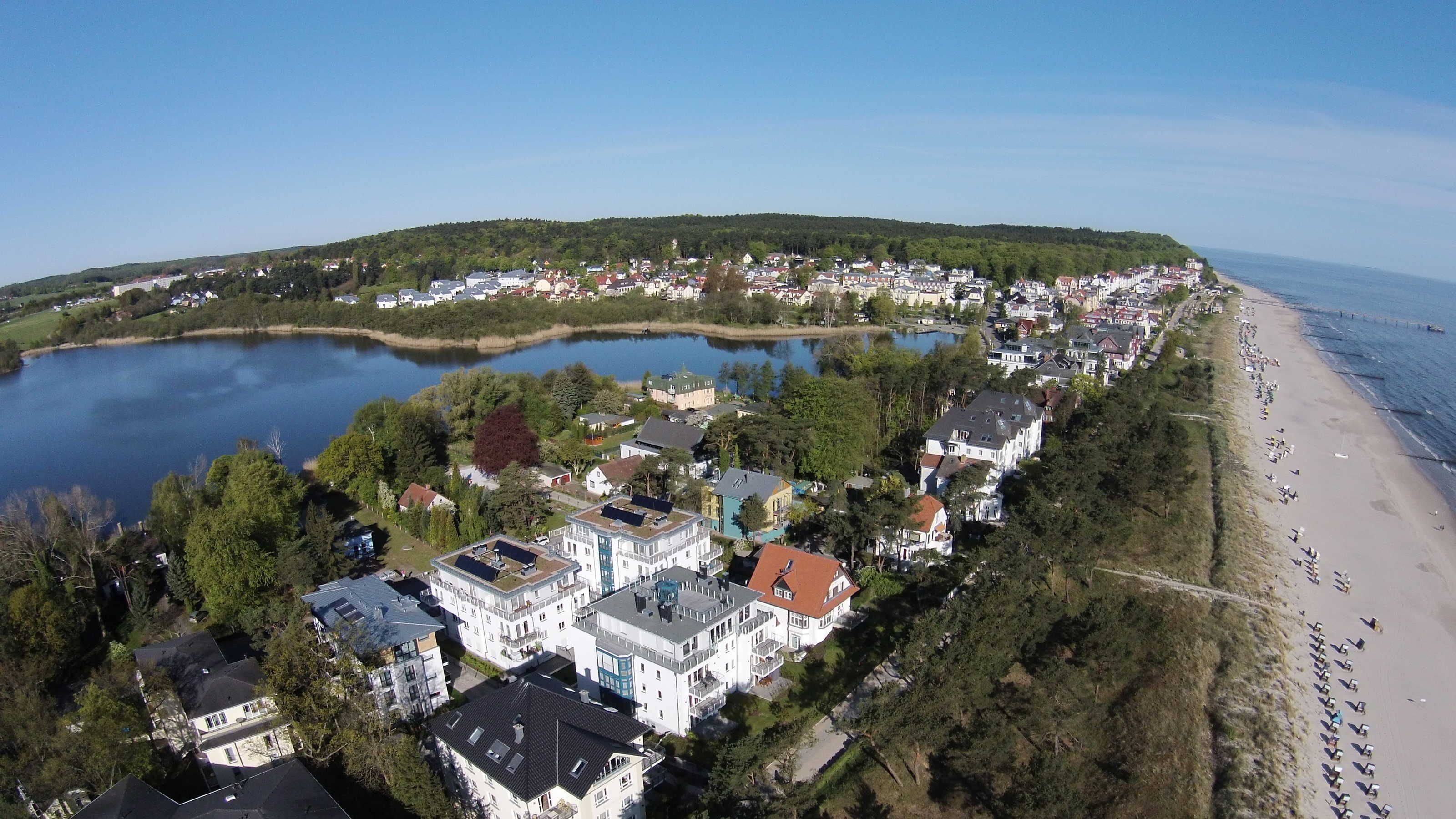 A coastal town with a lake, beach, and residential buildings.