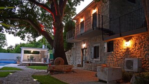 A stone building with a balcony, outdoor seating, and a stone pathway leading to a pool. - Villa Ana – Private Villa mit beheiztem Pool, großem Garten & Meerblick… (Zaostrog)