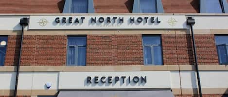 Recepción del Hotel Great North, con un cartel visible sobre la entrada.