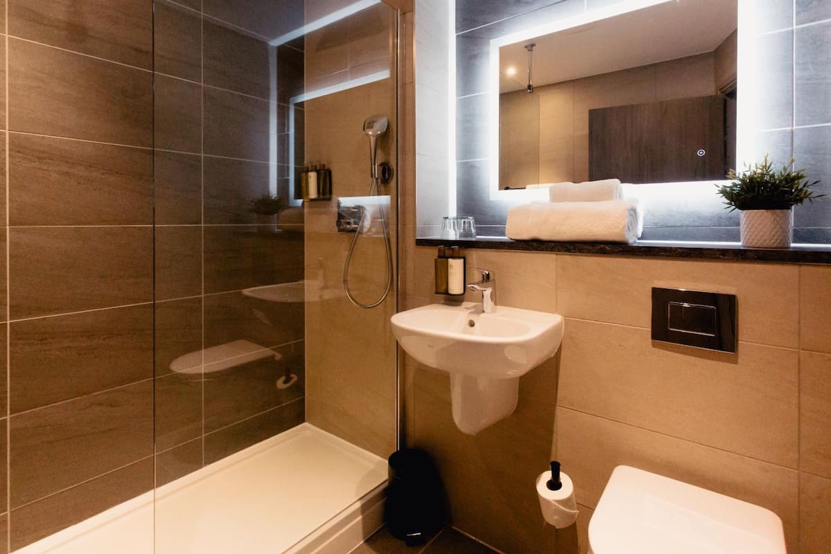 designer toiletries, hair dryer, towels, soap