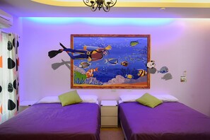 A bedroom with two beds, a mural of an underwater scene, and a ceiling fan. - Kenting Bay Homestay III (Hengchun)