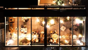 A restaurant with a large window display featuring various food items and decorations.