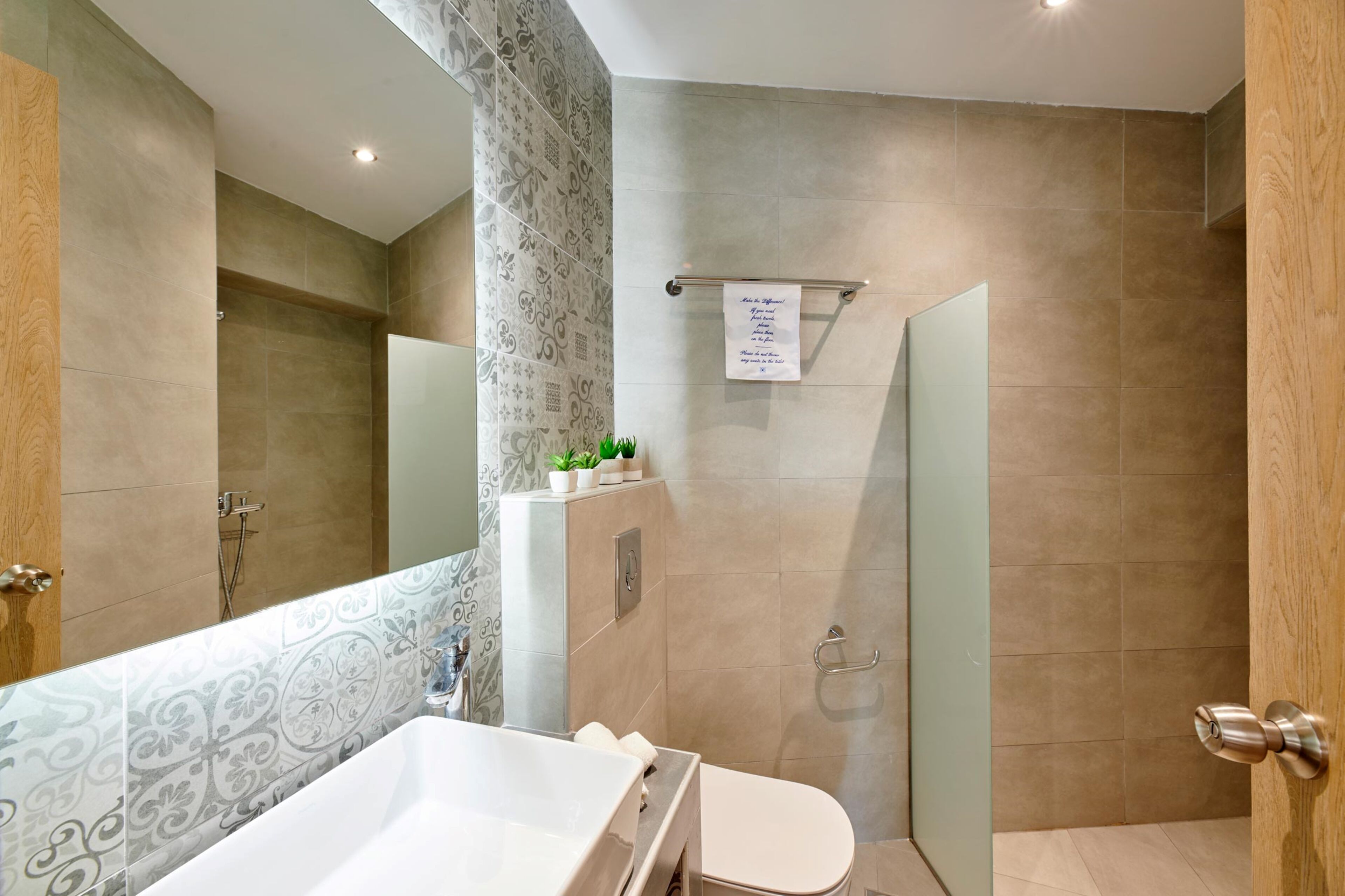 A bathroom with a large bathtub, a toilet, and a shower area.