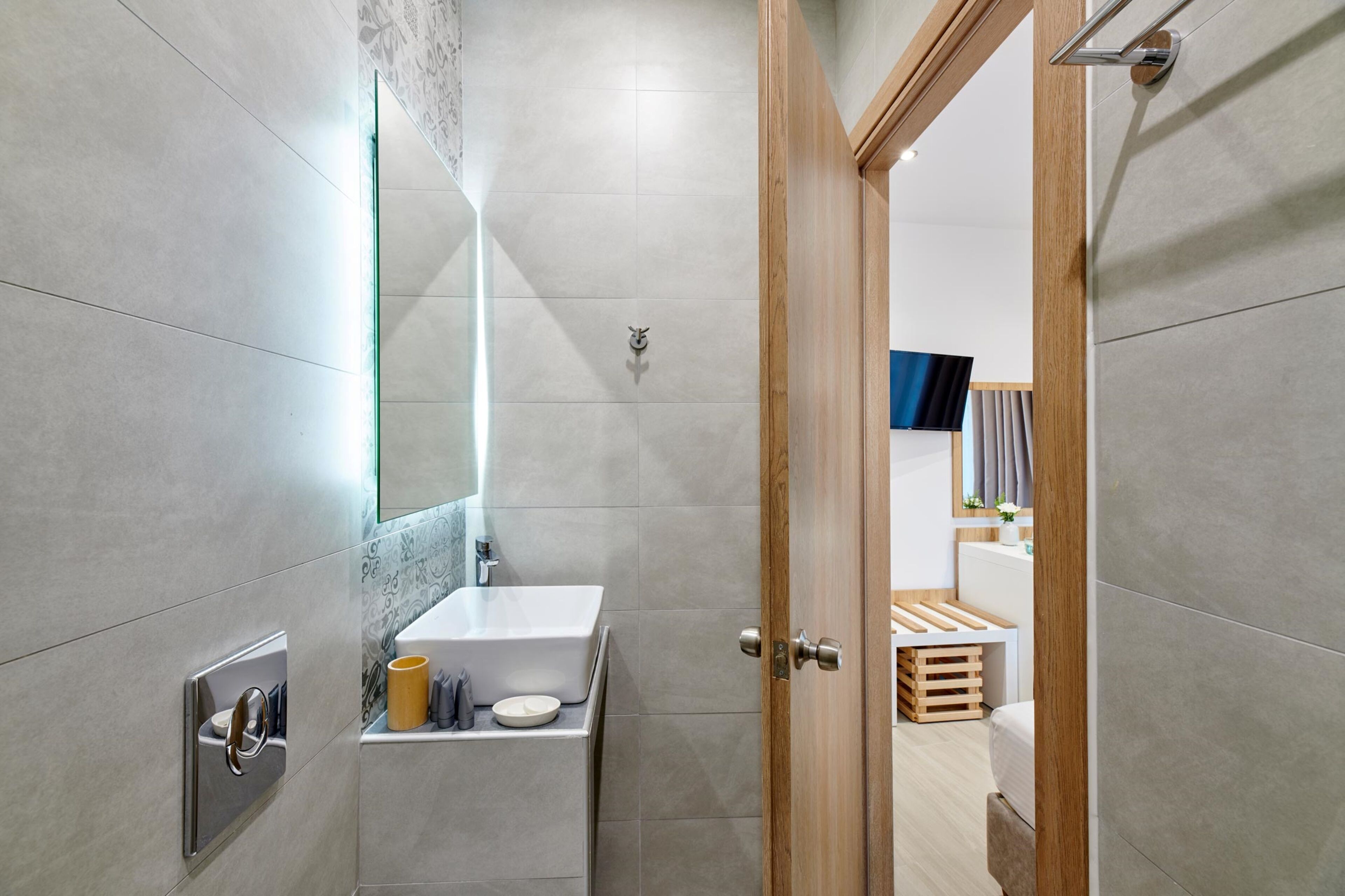 A modern bathroom with a shower, sink, and toilet.