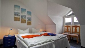 A bedroom with a bed, a desk, a chair, and a window. - 2 Room A 6 - Wohnpark Binz (with indoor pool) (Binz)