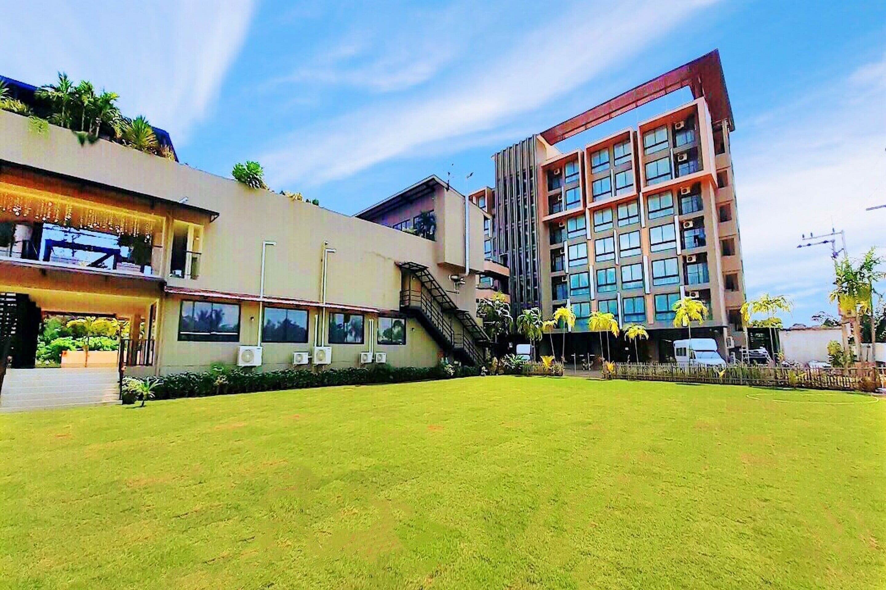 A modern building with a flat roof, large windows, and a central staircase.