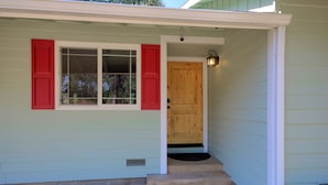 A house with a front door, a window with shutters, and a small porch area. - The Retreat@Lakeside Hot Tub/Views/Fast WiFi Near Yosemite! (Mariposa)