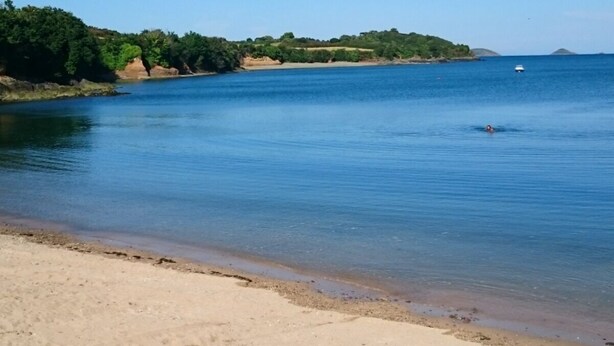 A beach with clear blue water, a sandy shore, and a person swimming. - The Hauts de Kerity, 1920's house by the sea (Paimpol)