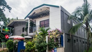 A two-story building with a balcony, surrounded by greenery and a sign for 'Rock Sar Pension'. - Roccksar Pension (Puerto Princesa)